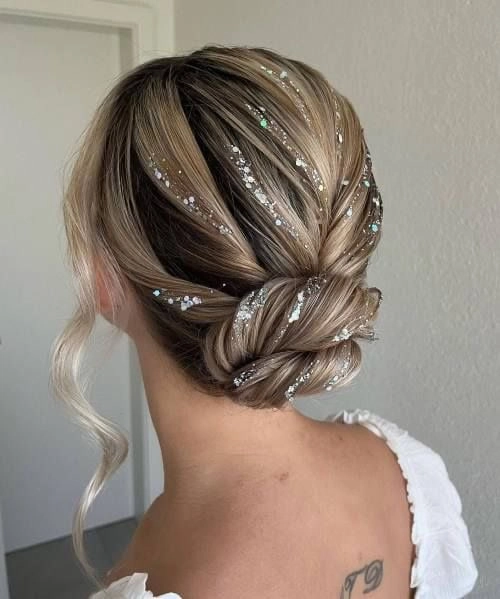 Elegant prom hairstyle featuring multiple small braids woven into an updo