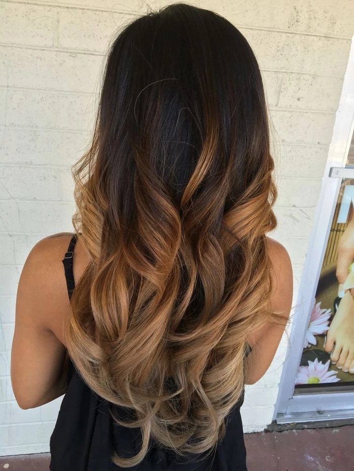 Elegant prom hairstyle showcasing caramel ombre hair with soft curls