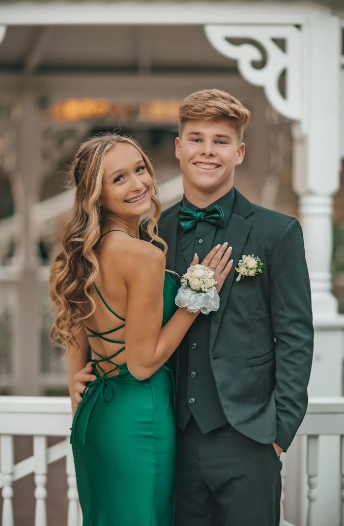 Elegant prom hairstyle with curls complementing a green dress