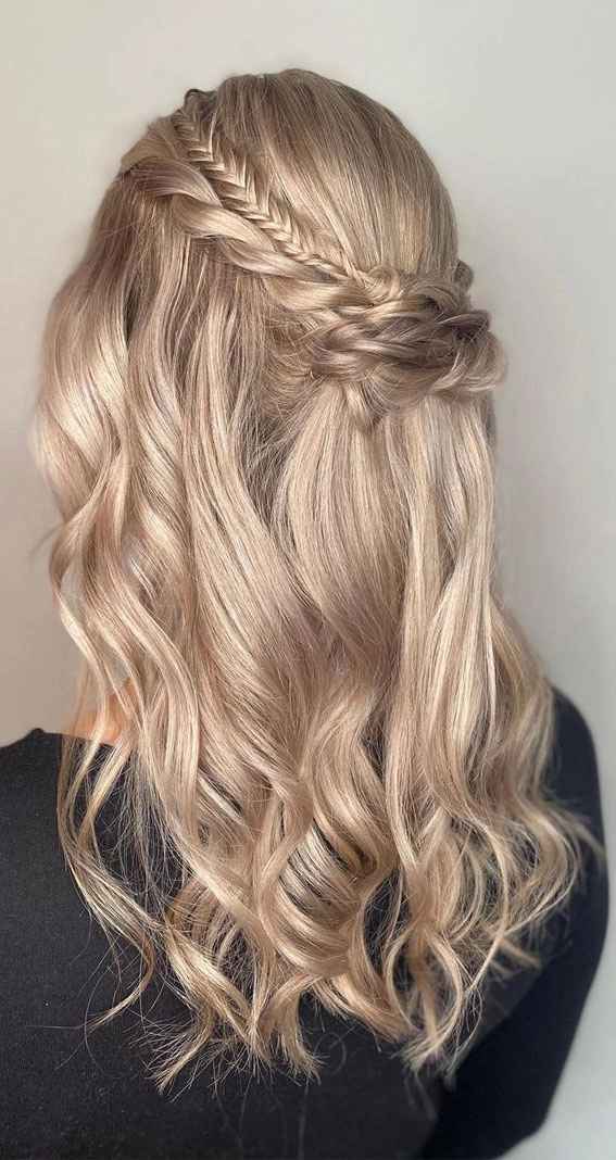 Elegant prom hairstyle with a fishtail braid and soft waves
