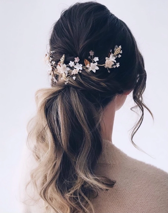 Prom hairstyle inspiration with floral hair vines for a graceful and romantic look Elegant prom hairstyle featuring delicate floral hair vines woven through soft curls