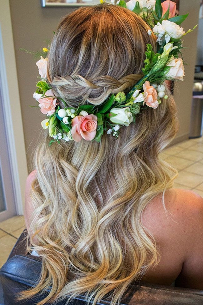 Elegant prom hairstyle featuring a fresh flower crown for a natural, romantic look