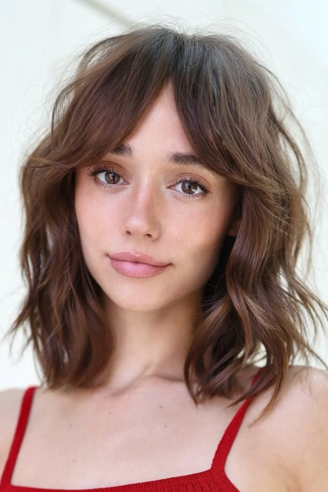 Prom hairstyles with bangs and curtain fringe perfect for a formal event Elegant prom hairstyle featuring bangs and curtain fringe with soft curls