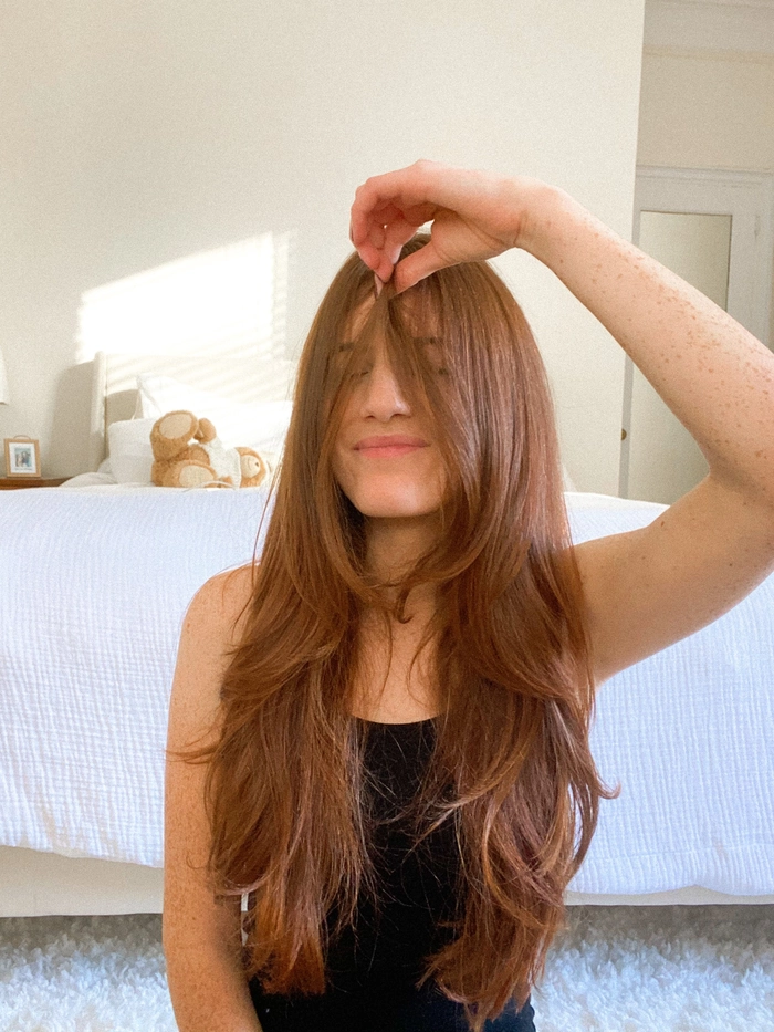 Stylish prom look with soft bangs and flowing curtain fringe hairstyle Elegant prom hairstyle featuring bangs and a curtain fringe