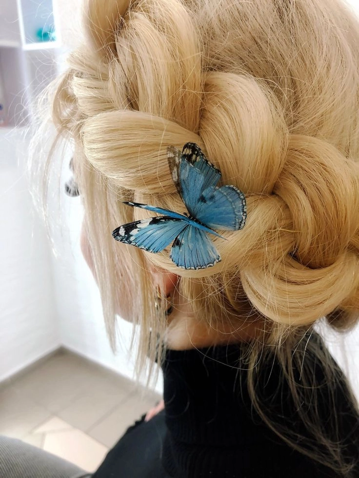Elegant prom hairstyle adorned with delicate butterfly hair pins for a whimsical look