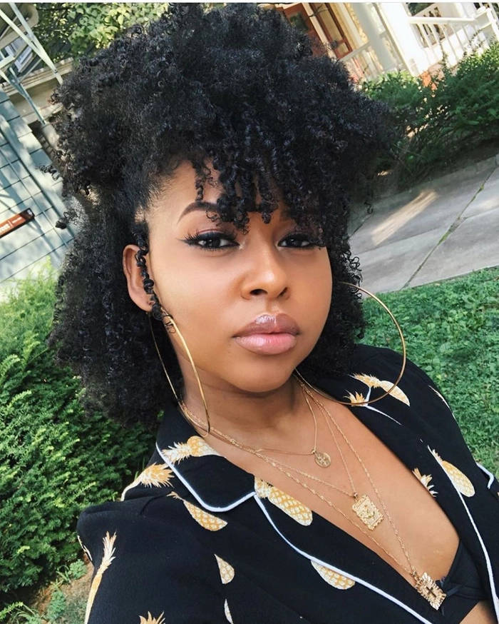 Elegant prom hairstyle for tightly coiled natural hair with defined curls and decorative accessories