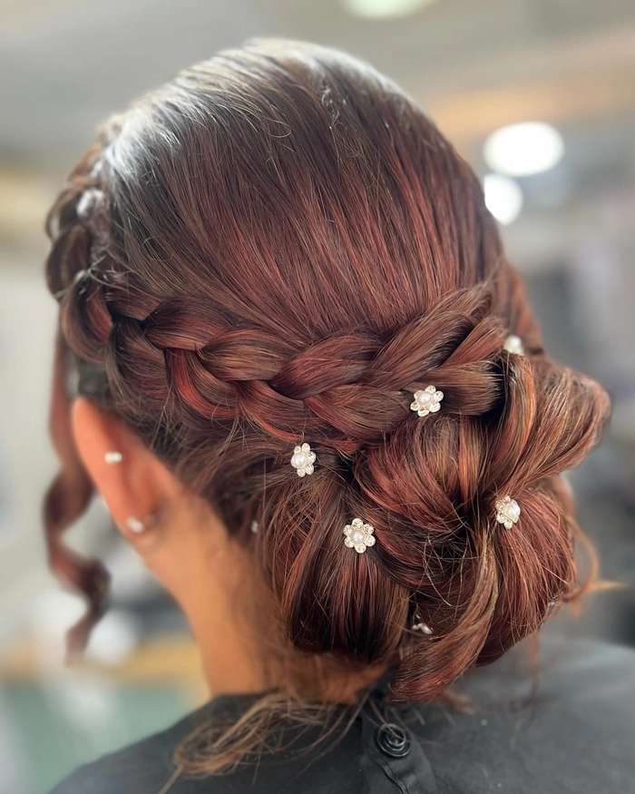 Elegant prom hairstyle for tightly coiled natural hair featuring defined curls and decorative accessories