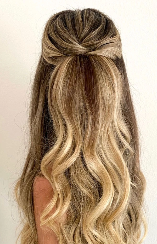 Elegant prom hairstyle featuring hair extensions and weaves for added volume
