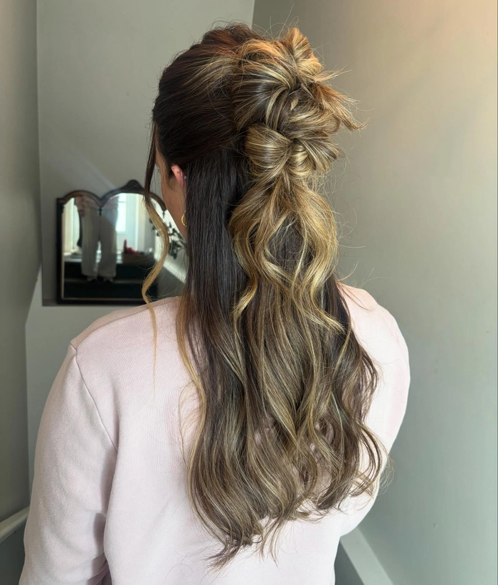 Elegant prom hairstyle featuring face framing tendrils softly curled around the face