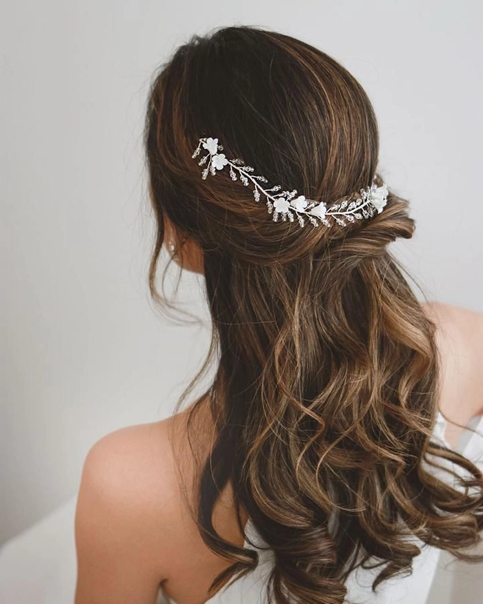 Stunning prom look showcasing delicate floral hair vine accessories Elegant prom hairstyle featuring floral hair vines woven through loose curls