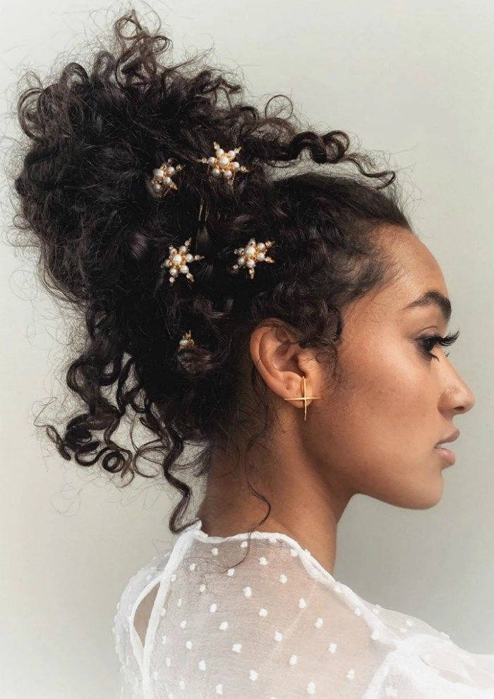 Elegant prom hairstyle featuring jeweled hair cuffs and soft curls