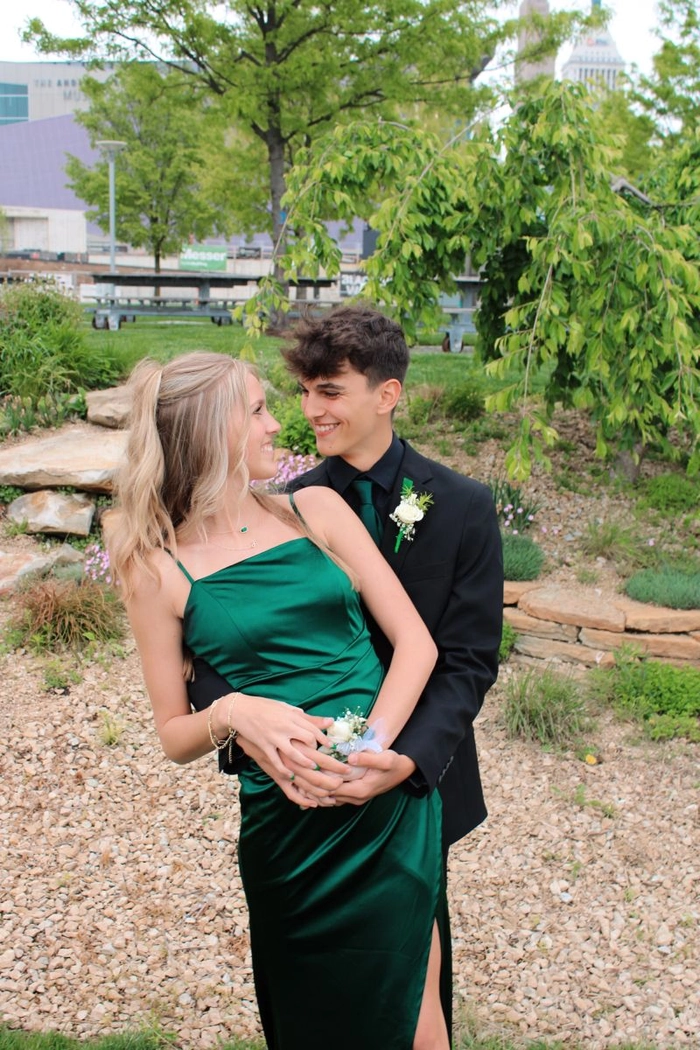 Elegant prom hairstyle featuring loose curls perfect to match a green dress