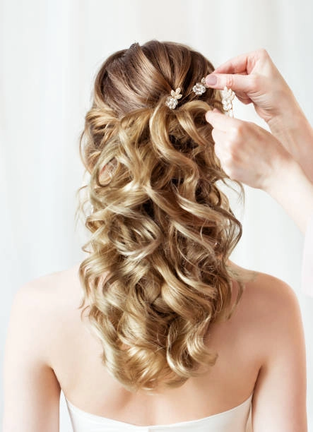 Elegant prom hairstyle with loose curls for strapless prom dress