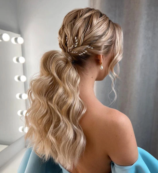 Elegant prom hairstyle featuring loose curls for off the shoulder dresses