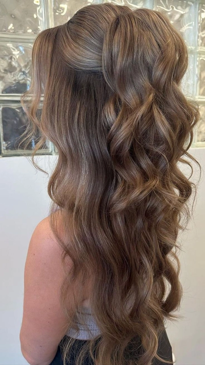 Elegant prom hairstyle featuring loose curls ideal for a beach venue