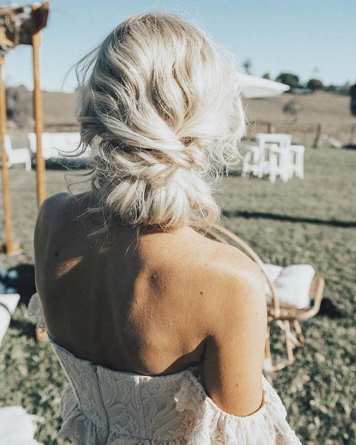 Elegant prom hairstyle featuring loose curls perfect for a rustic barn venue
