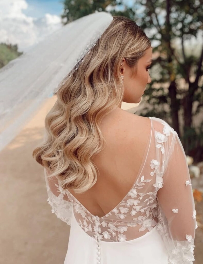 Elegant prom hairstyle with loose waves perfect for a beach venue