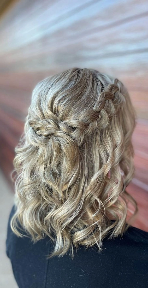 Chic middle part prom hairstyle with flowing curls for a glamorous look Elegant prom hairstyle featuring a sleek middle part with soft curls