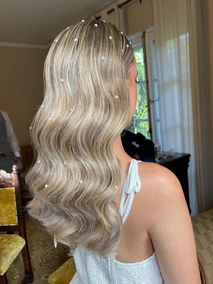 Elegant prom hairstyle featuring pearl hair accessories