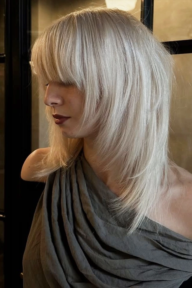 Elegant prom hairstyle featuring pearl hair accessories and soft curls