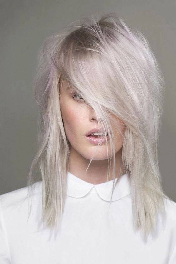 Elegant prom hairstyle for platinum blonde hair featuring soft curls and volume