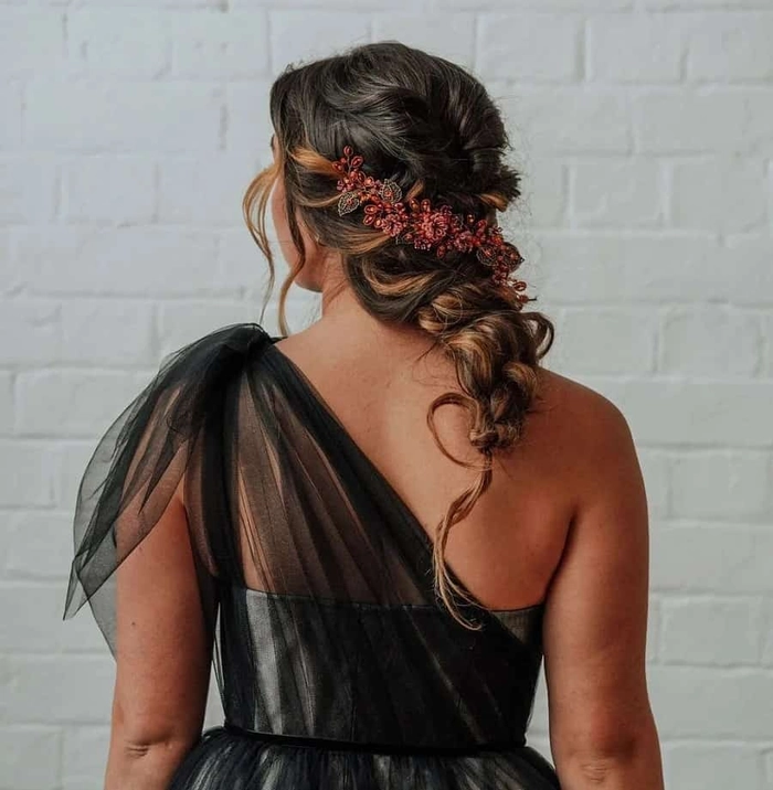 Elegant prom hairstyle showcasing soft curls styled to one side for a one shoulder gown