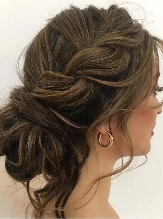 Elegant prom hairstyle complementing off the shoulder dress with soft curls