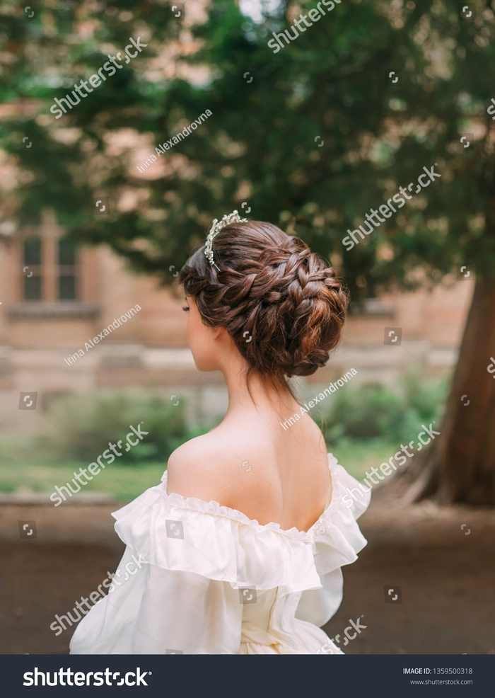 Prom hairstyles with delicate tiaras showcasing timeless beauty and grace Elegant prom hairstyle featuring a delicate tiara and soft curls