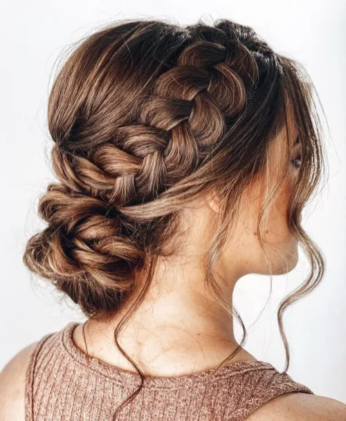 Elegant prom hairstyle featuring face framing tendrils with soft curls