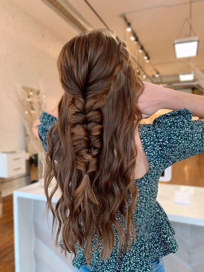 Elegant prom hairstyle with soft curls complementing a black dress