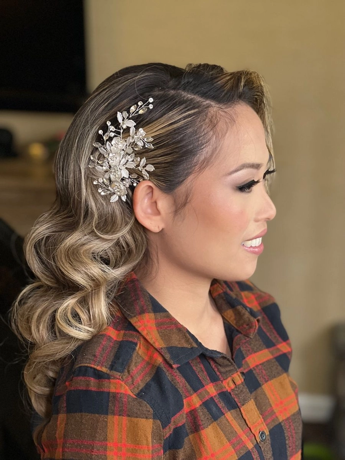 Elegant prom hairstyle featuring soft curls to complement a black dress