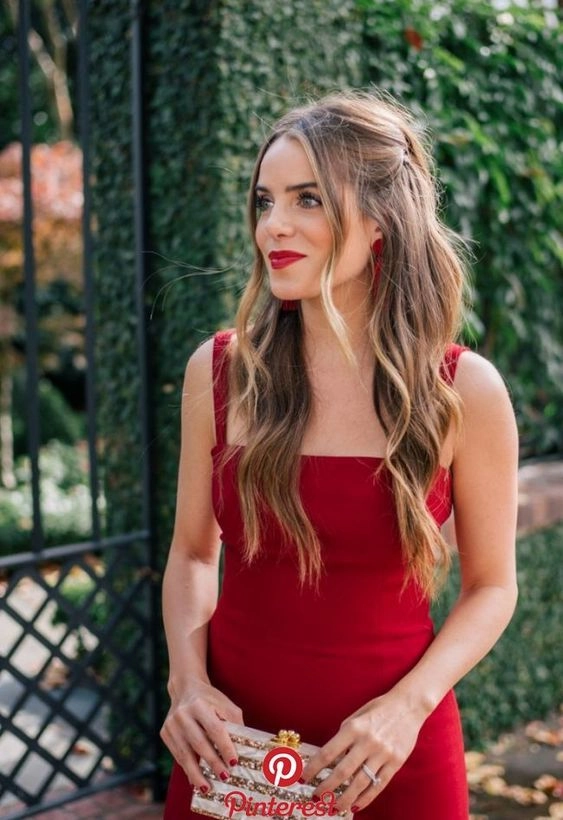 Elegant prom hairstyle featuring soft curls to match a red dress