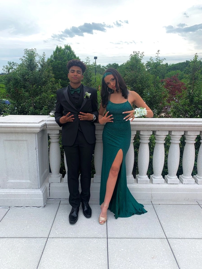 Elegant prom hairstyle featuring soft curls to match a green dress