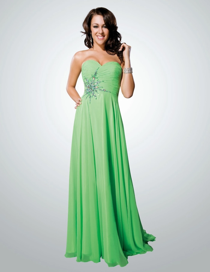 Elegant prom hairstyle with soft curls complementing a green dress