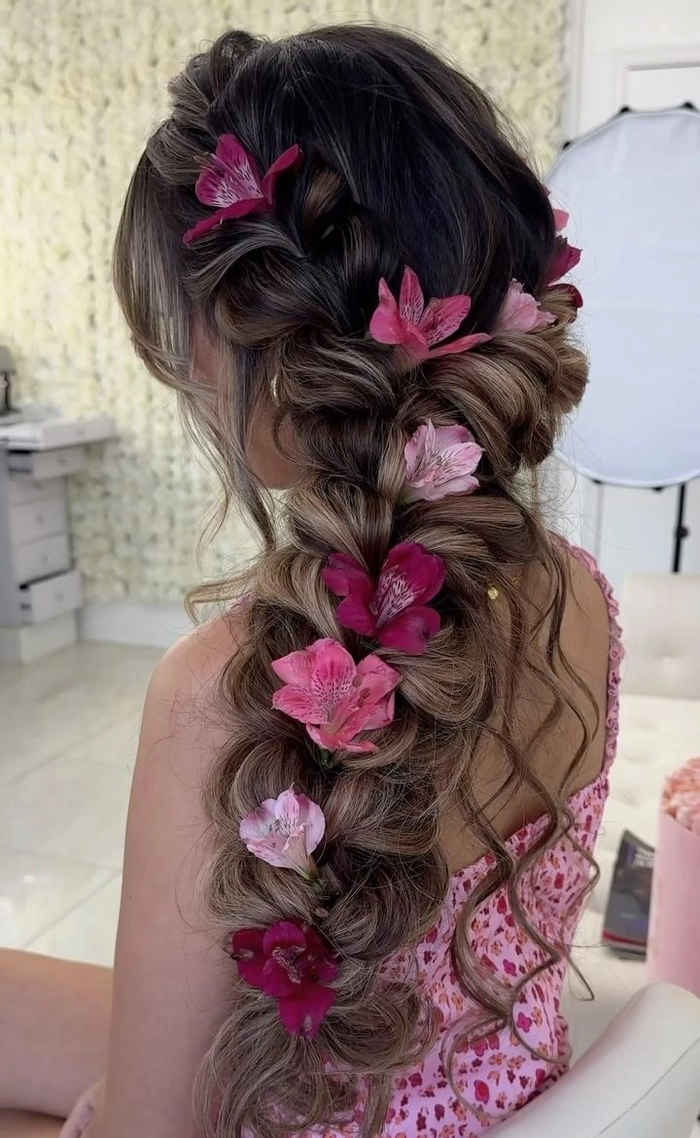 Chic prom hairstyle ideas for outdoor garden settings, image 14 Elegant prom hairstyle with soft curls adorned with flowers, perfect for a garden venue