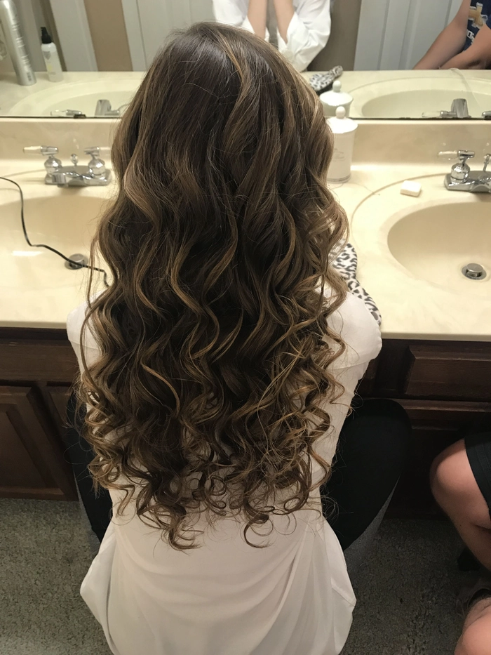 Prom Hairstyles for Long Wavy Hair Inspiration Image 10 Elegant prom hairstyle for long wavy hair with soft curls and delicate accessories