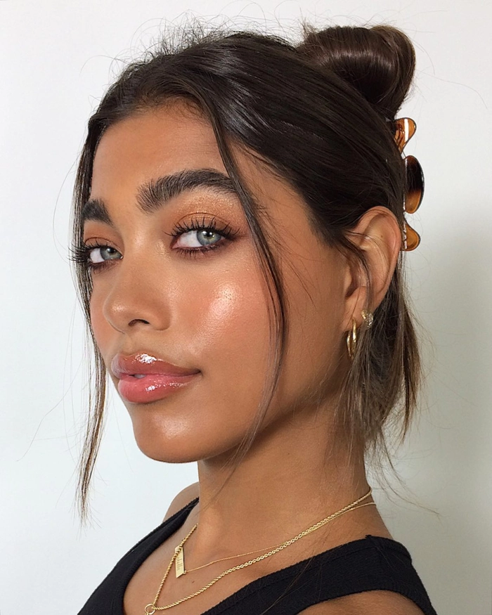 Elegant prom hairstyle featuring delicate face framing tendrils for a soft, romantic look