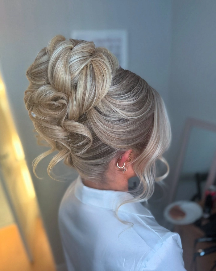 Elegant prom hairstyle featuring soft face framing tendrils for a romantic look