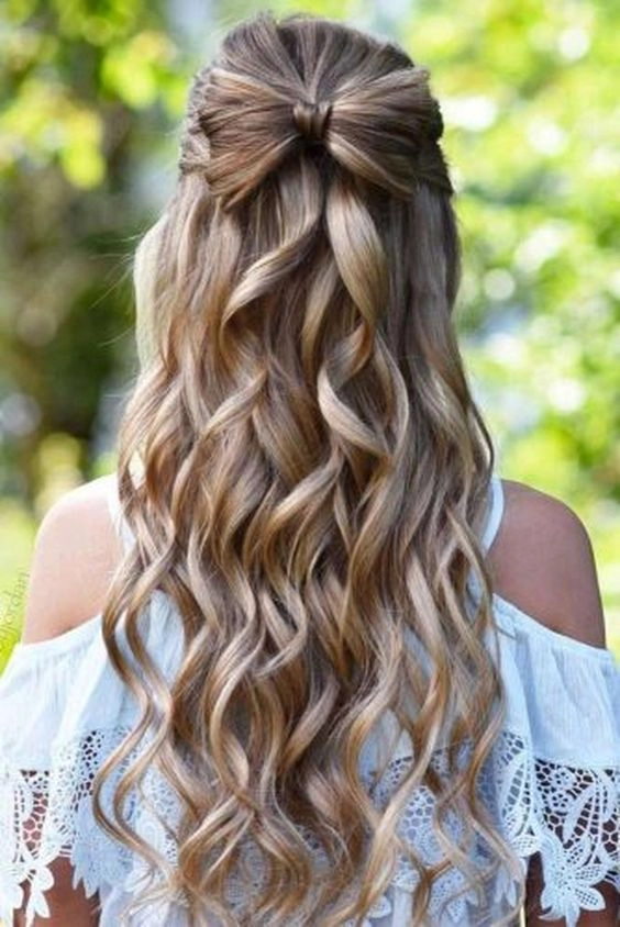 Stunning long thick hair styled perfectly for a memorable prom night look Elegant prom hairstyle for long thick heavy hair featuring intricate braids and volume