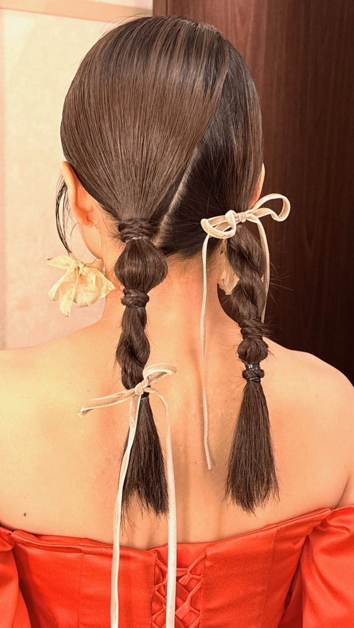 Elegant prom hairstyle featuring velvet ribbons woven into soft curls