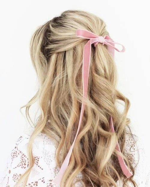 Elegant prom hairstyle featuring velvet ribbons woven into soft curls