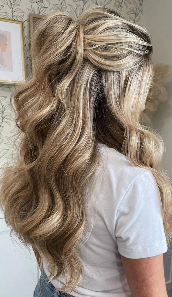 Stunning curled half up half down prom hairstyle perfect for formal events Elegant half up half down prom hairstyle featuring soft curls and volume