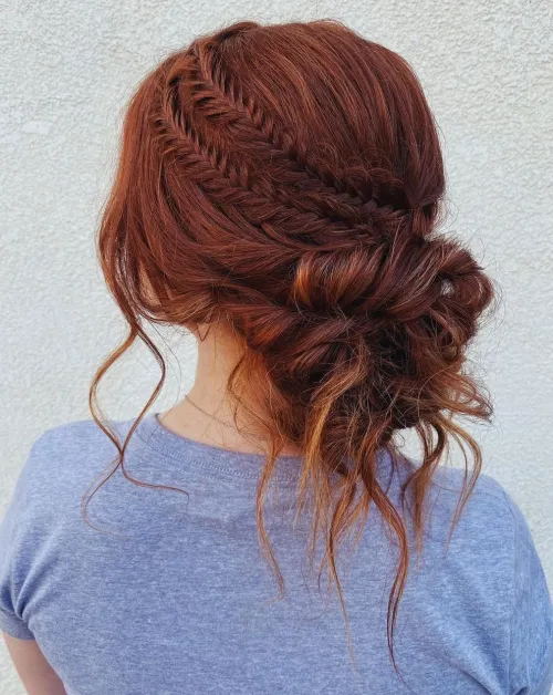 Elegant prom hairstyle featuring a high messy bun with loose curls