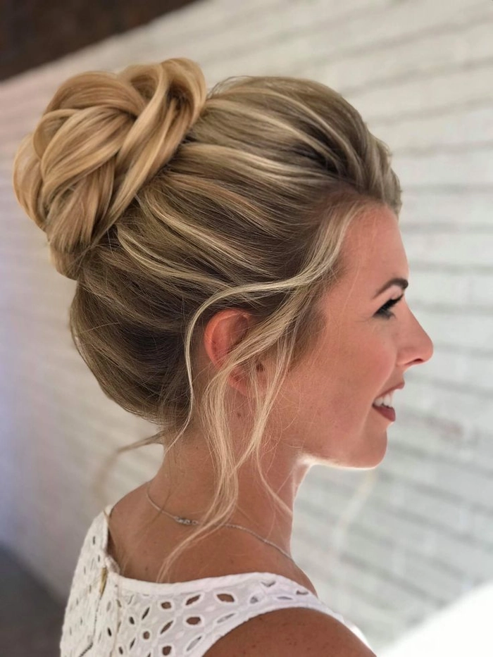 Elegant prom hairstyle featuring a high messy bun for a chic look