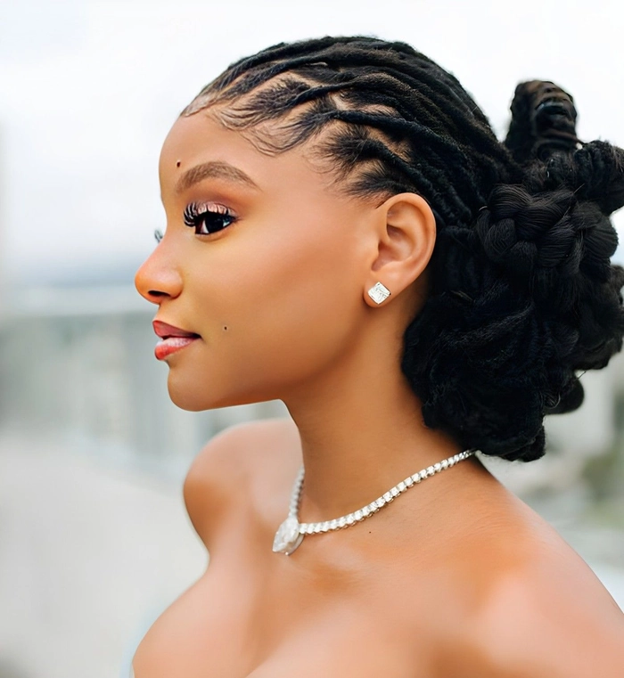 Elegant prom hairstyle featuring locs styled with delicate accessories