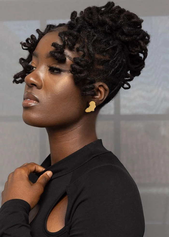Elegant prom hairstyle featuring locs styled with decorative beads and curls