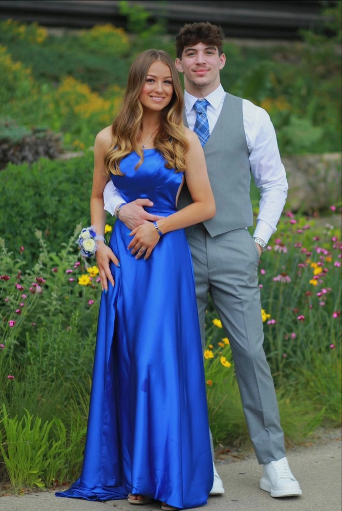 Elegant prom hairstyle featuring loose curls to match a blue dress