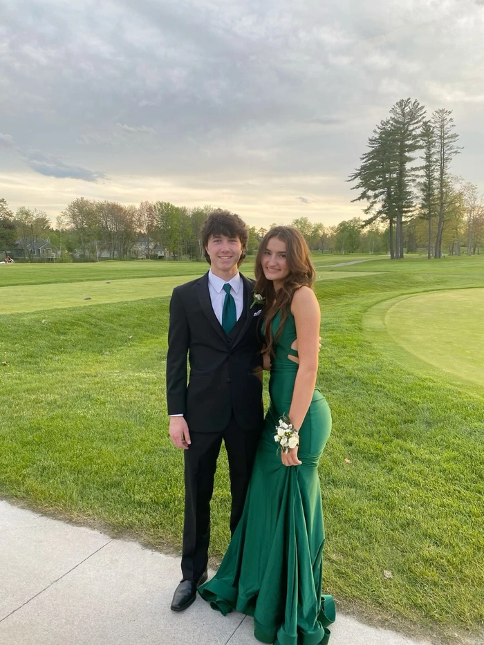 Elegant prom hairstyle featuring loose curls to match a green dress