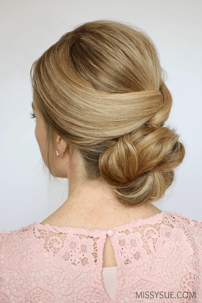 Elegant prom hairstyle featuring a low nape bun with soft curls