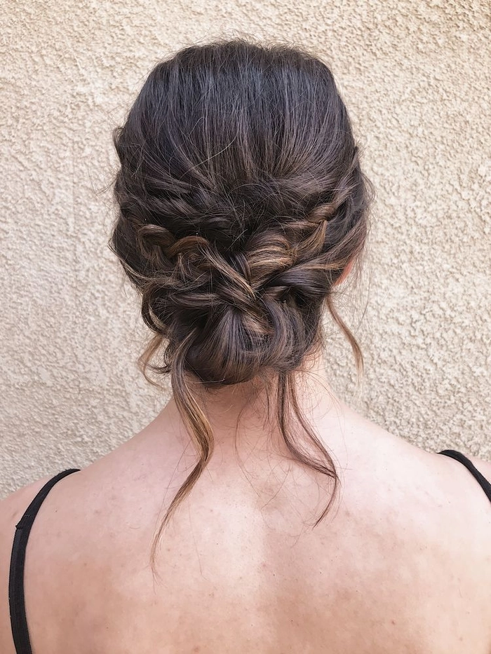 Elegant prom hairstyle featuring a low nape bun with soft curls